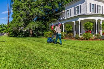Worker aerating a lawn