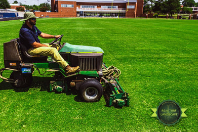 Bryce mowing the FVSU football field in Fort Valley