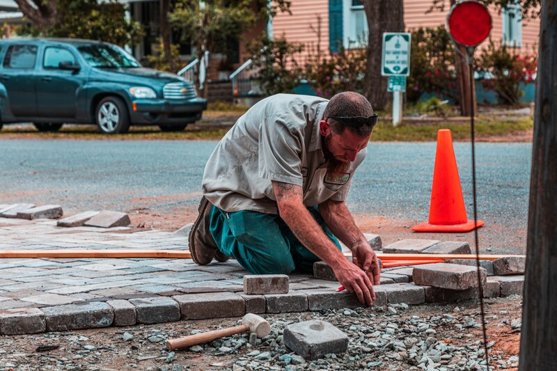 Worker installing a hardscape driveway