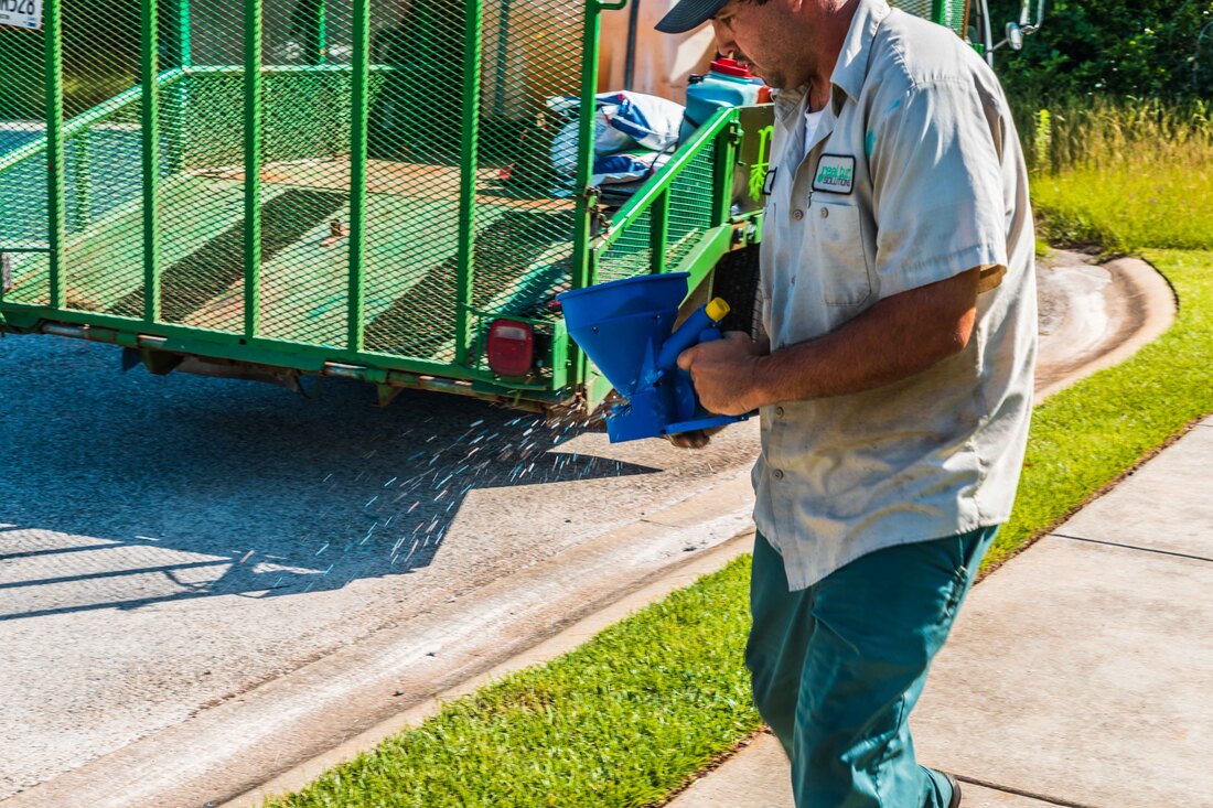 Worker applying fertilizer