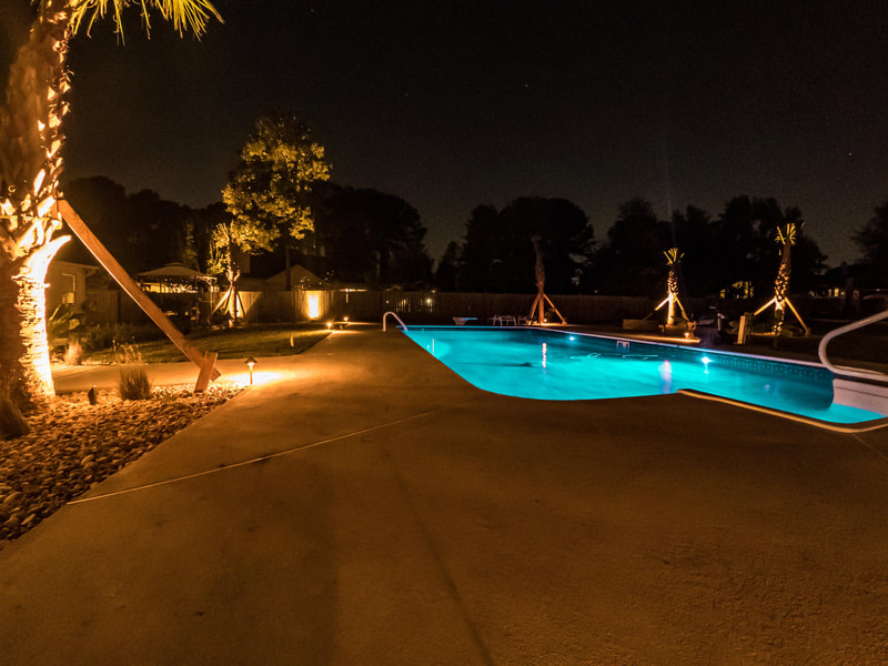 Landscape lighting around a pool
