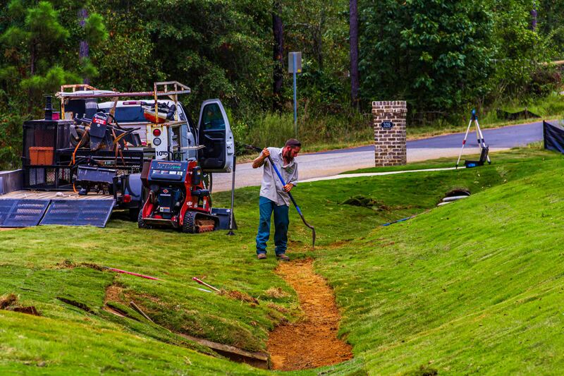 Laying sod in a ditch by the street