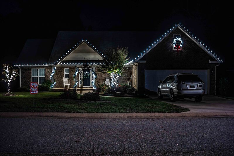 Professionally installed holiday lighting on a house