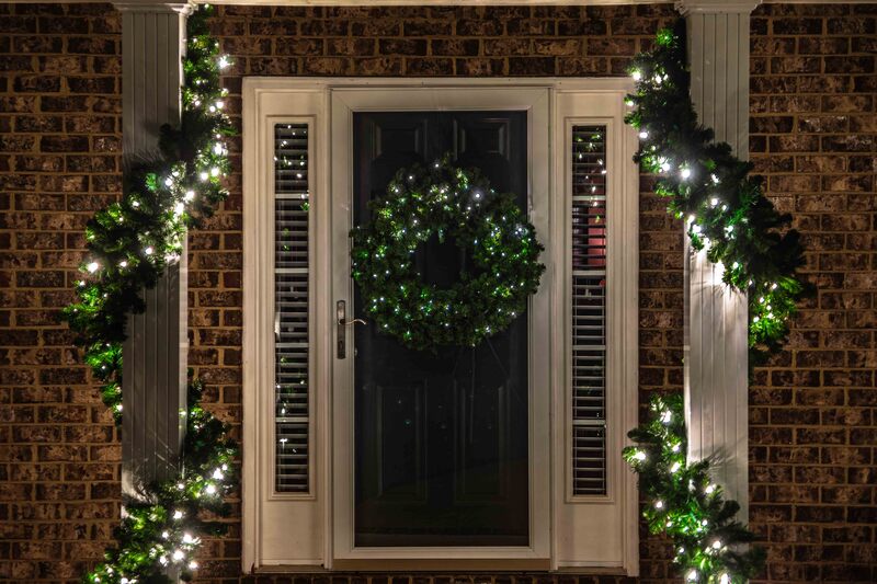 Wreath and garland decorating a front porch