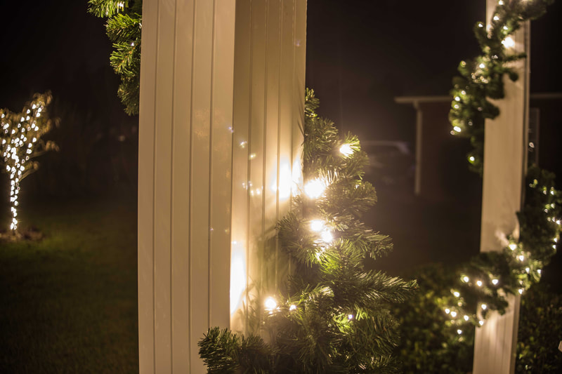 Holiday lighting garland on a column