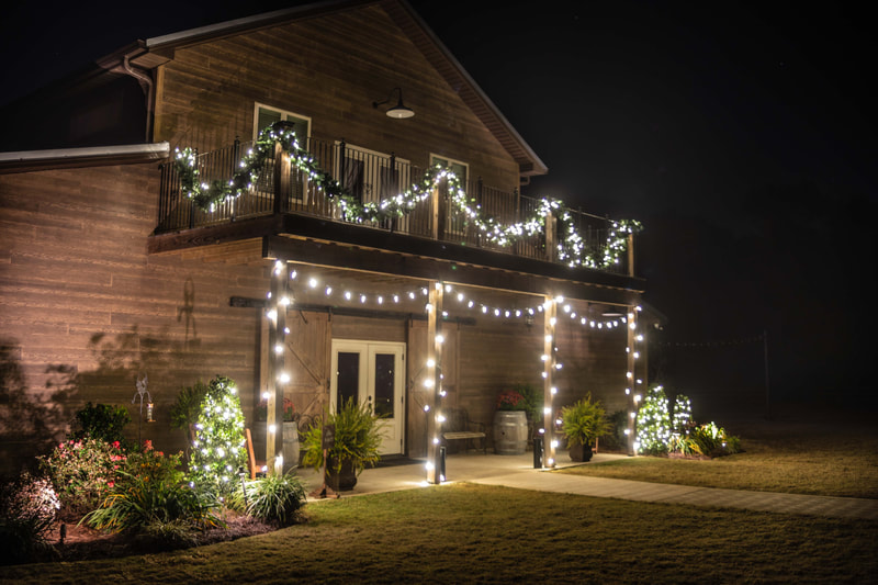 Christmas lights installed on a barn